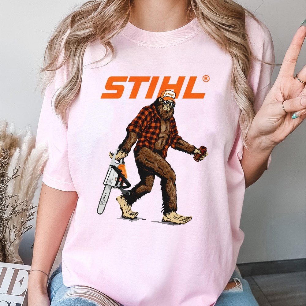 Bigfoot With Chainsaw Graphic T-Shirt | Retro Lumberjack Sasquatch Print | Premium 100% Cotton Tee | Gift for Woodsman and Ou